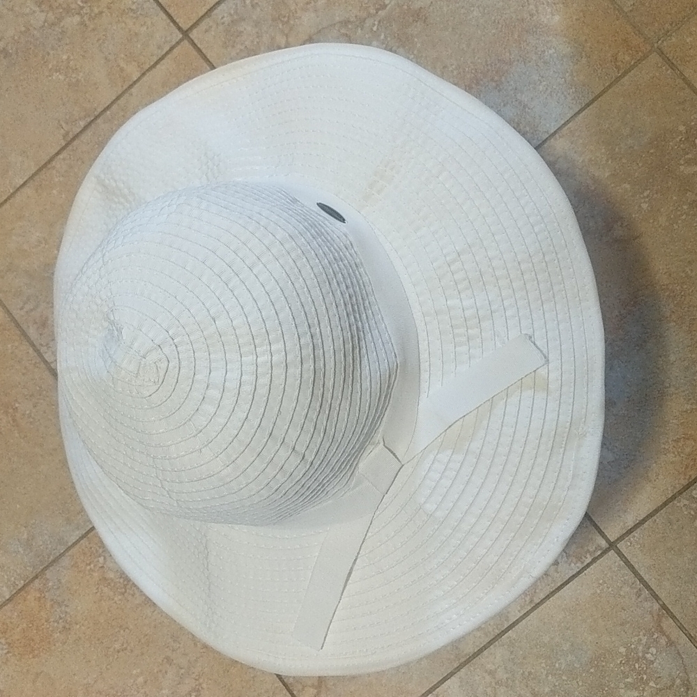 Coolibar brand 50+ SPF in White ribbon hat with wire in the rim.
